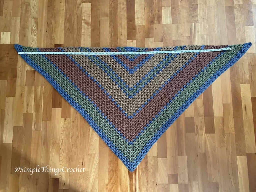 Autumn Woods Wrap crochet shawl laid flat displaying the granny stitch pattern and size